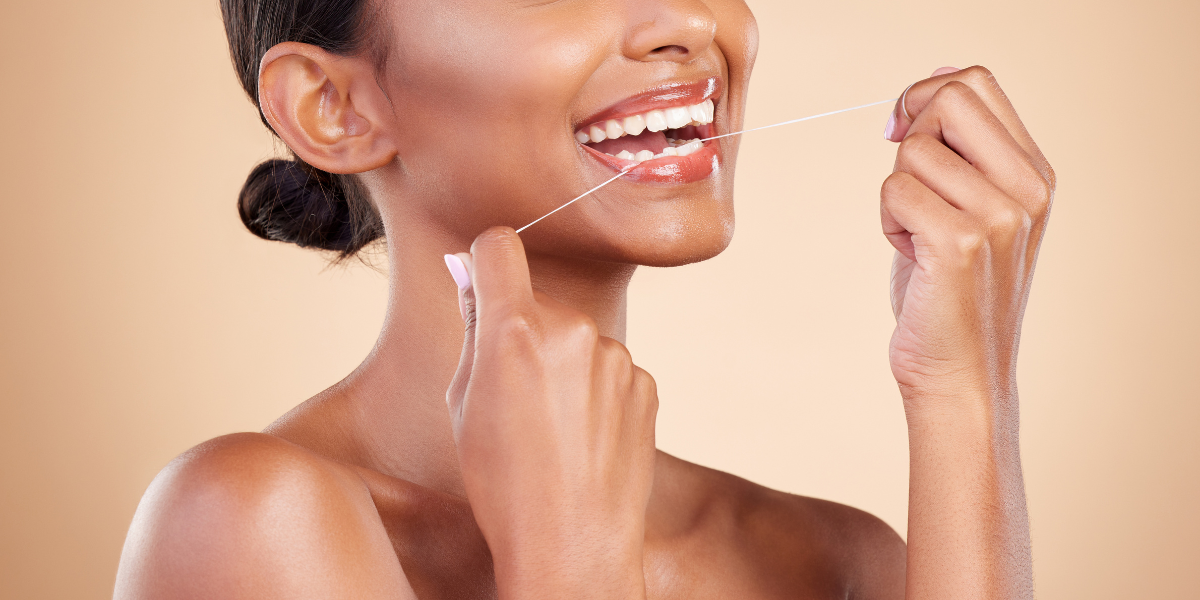 MABLE Blog post: reasons you should brush your teeth, woman flossing her teeth