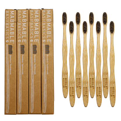 Set of MABLE Basics bamboo toothbrushes with black bristles, alongside eco-friendly cardboard packaging